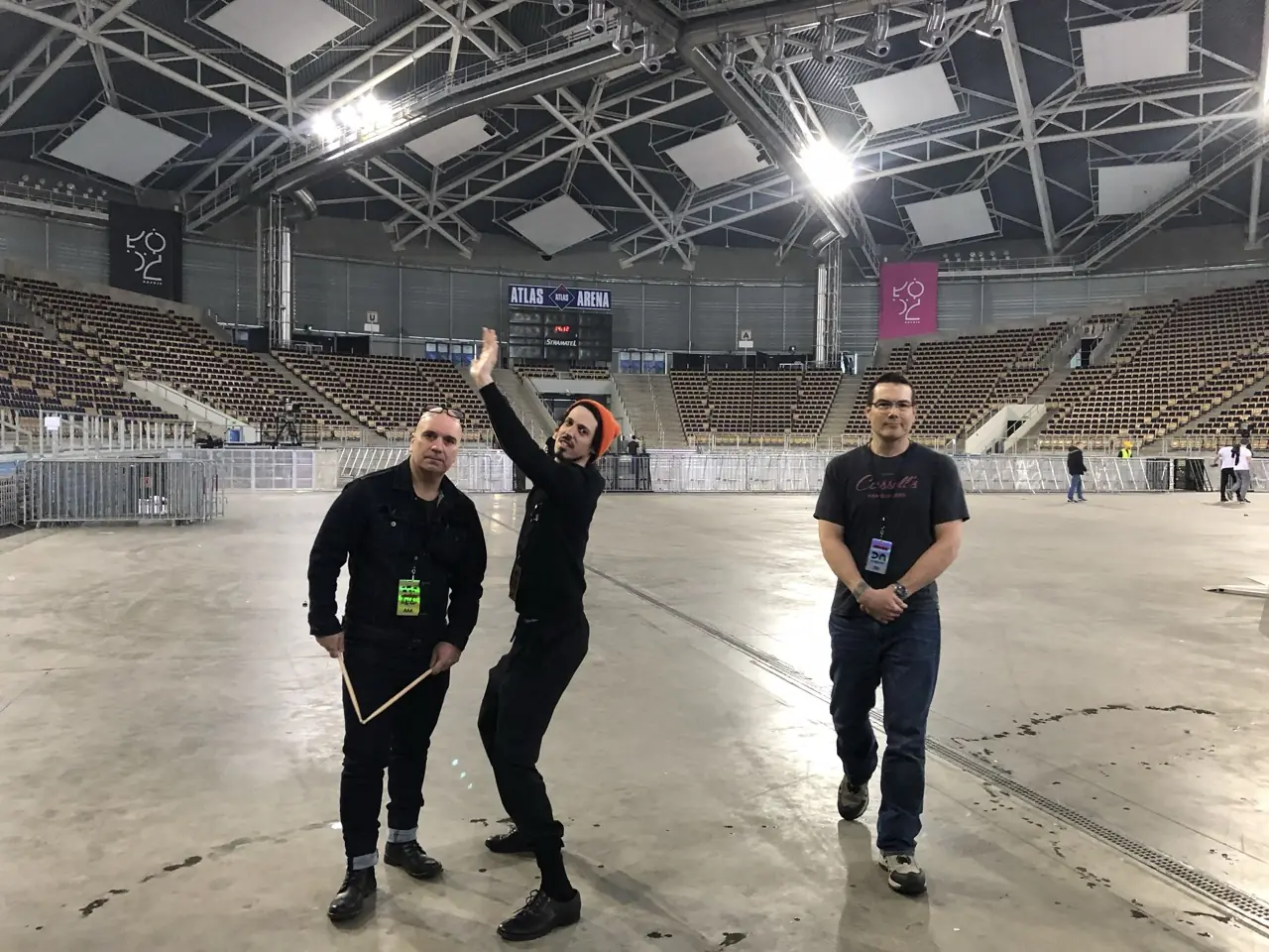 Bon Harris, Zack Meyers and Ken "hiwatt" Marshall on the floor of an empty arena, the Atlas Arena sign behind them, Black Line on tour with Depeche Mode
