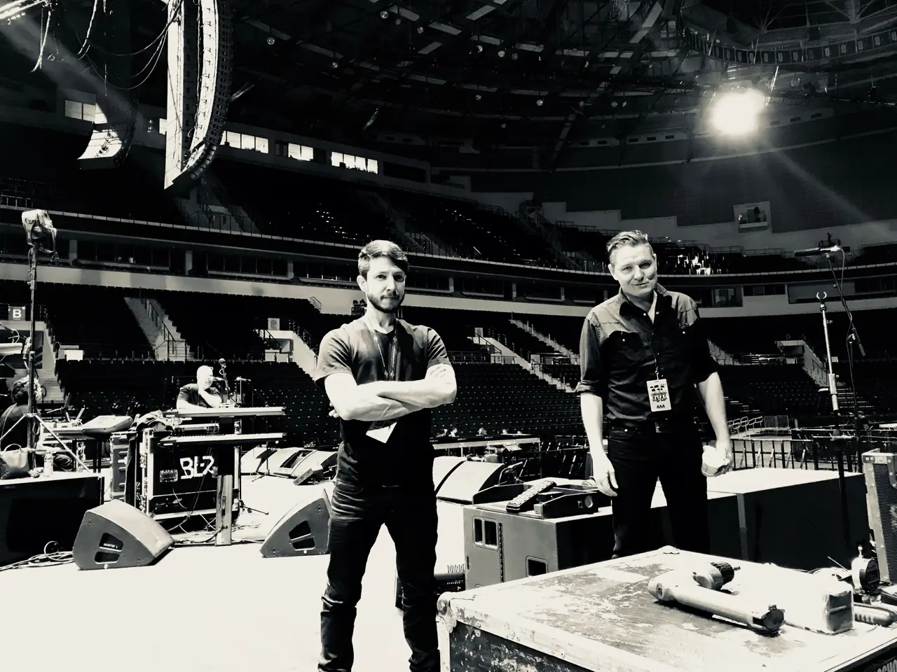 Black and white: two men on an arena stage before a show on the Black Line tour