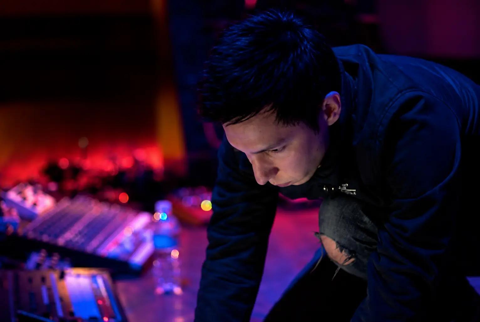 Cyrus leaning over his gear in purple light at the Knitting Factory, Hollywood
