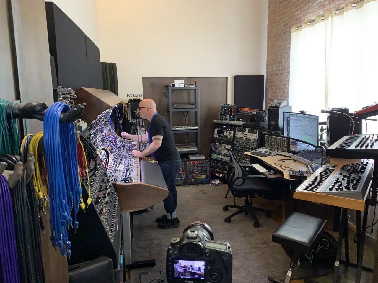 A camera on a tripod in the Los Angeles studio, Bon Harris at the modular console