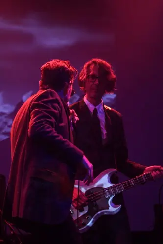 Paul Barker on bass beside Douglas J. McCarthy on a red-lit stage: Black Line live at the Teragram Ballroom