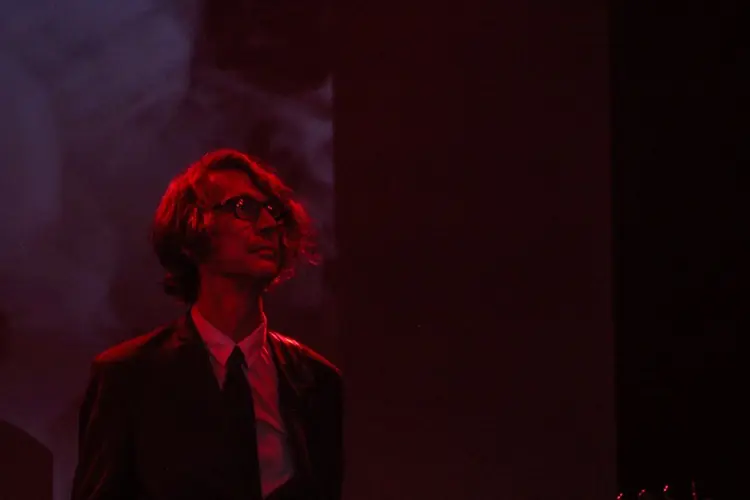 Paul Barker in red light on a dark stage: Black Line live at the Teragram Ballroom