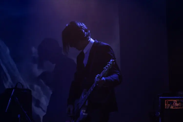 Paul Barker playing bass in blue light: Black Line live at the Teragram Ballroom