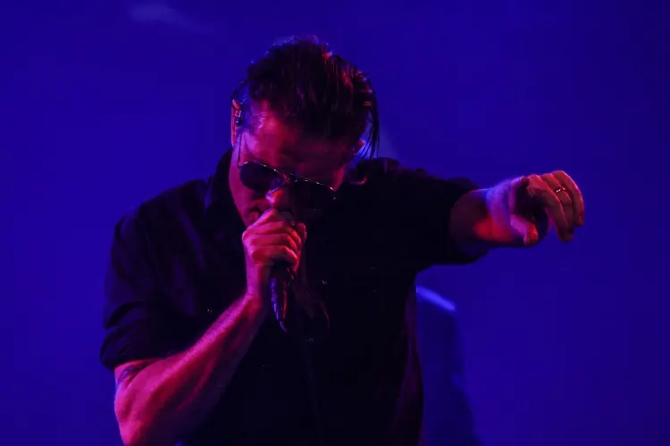 Douglas J. McCarthy singing against a deep blue backdrop: Black Line live at the Teragram Ballroom