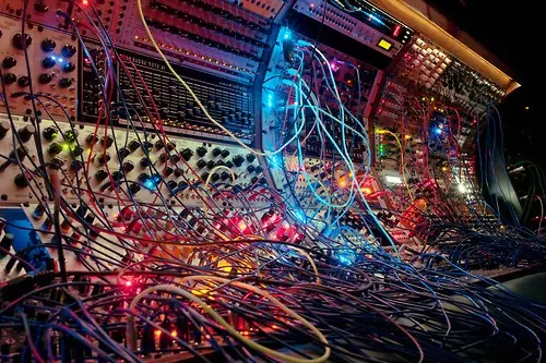 A large modular synth covered in colourful patch cables