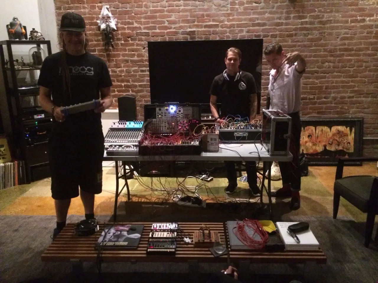 cEvin Key, Douglas J. McCarthy and Rodent with modular gear on a table in a brick-walled room