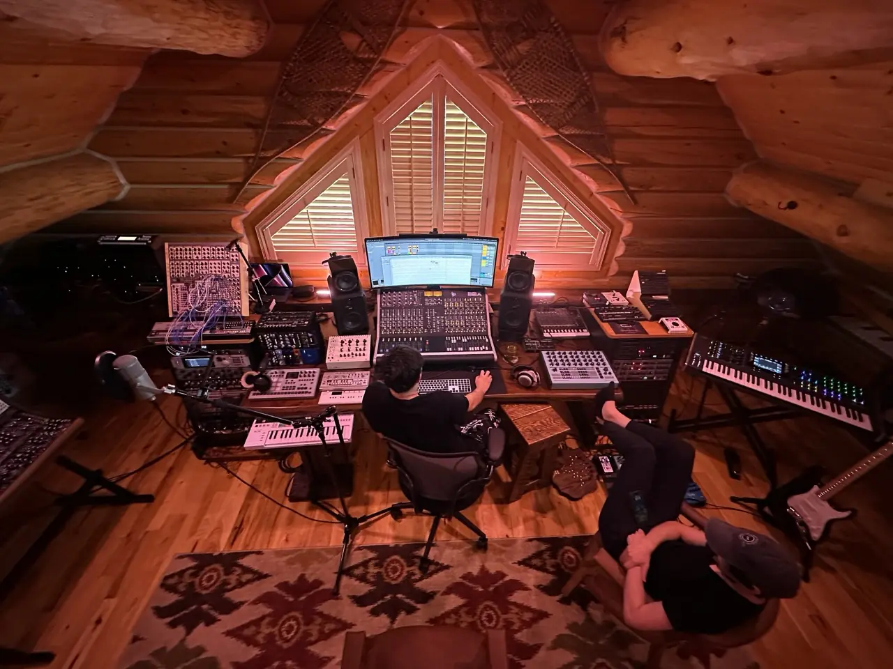 Talent Show sessions in the Montana studio: one at the desk, one leaning back, the attic window behind