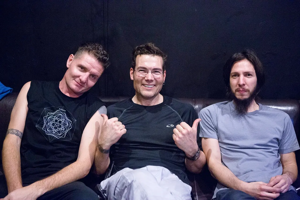 Ken "hiwatt" Marshall, Douglas J. McCarthy and Cyrus on a couch backstage at the DJMREX show with Skinny Puppy