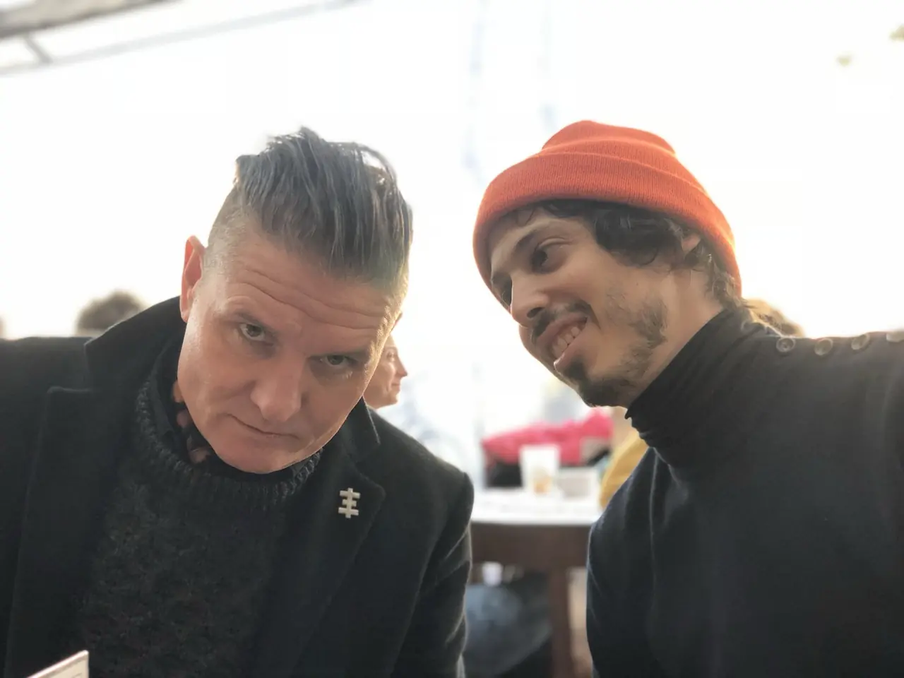 Douglas J. McCarthy and Zack Meyers in a selfie at a café in Poland, mid-tour