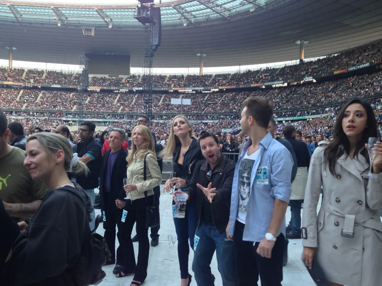 Family visiting the Stade de France show, in the crowd on the stadium floor