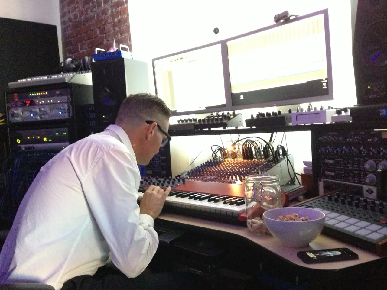 Douglas J. McCarthy at the keyboard and mixing desk in the studio