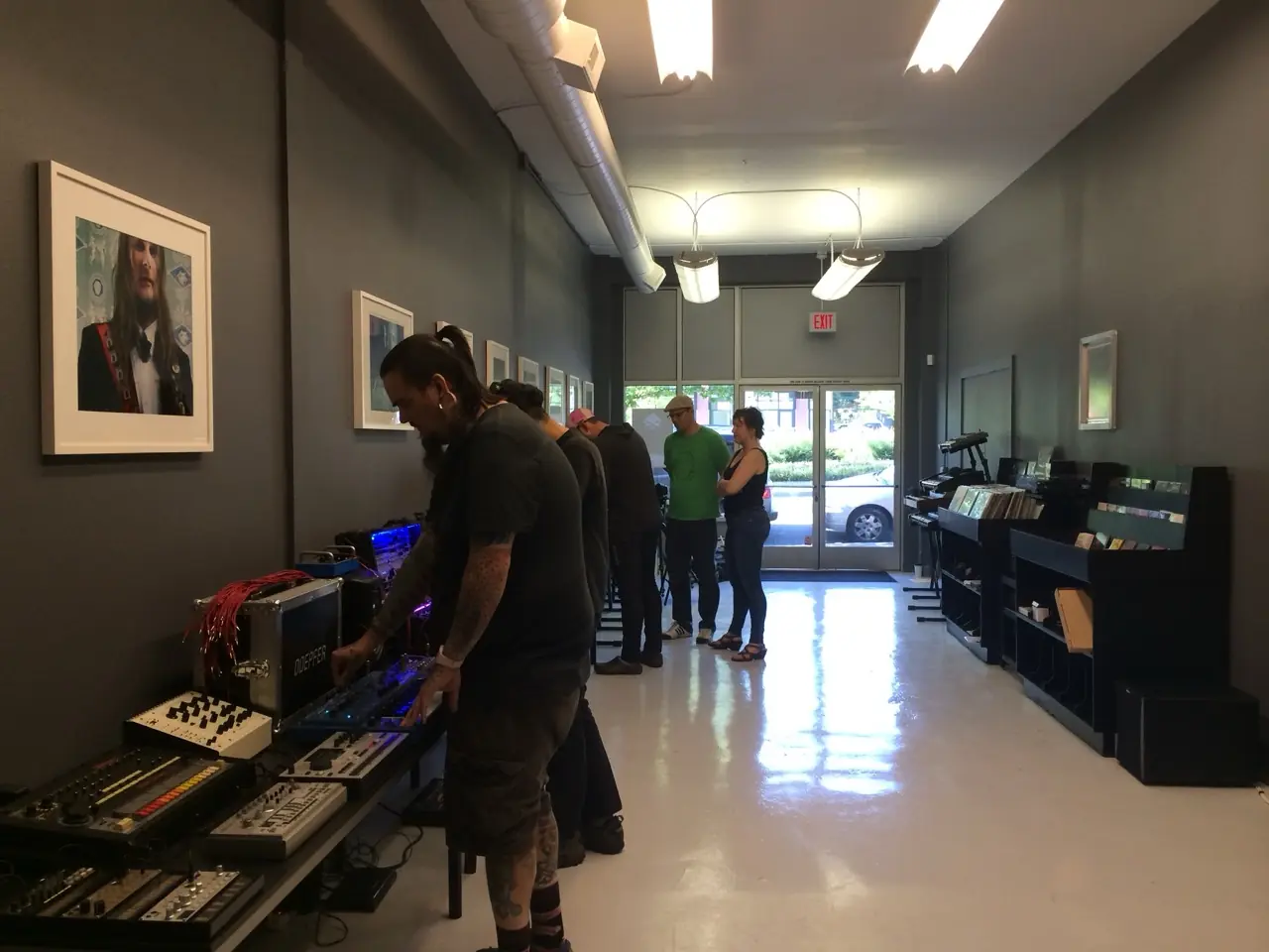 The Muffwiggler Store opening in Portland: people trying out synths on long tables